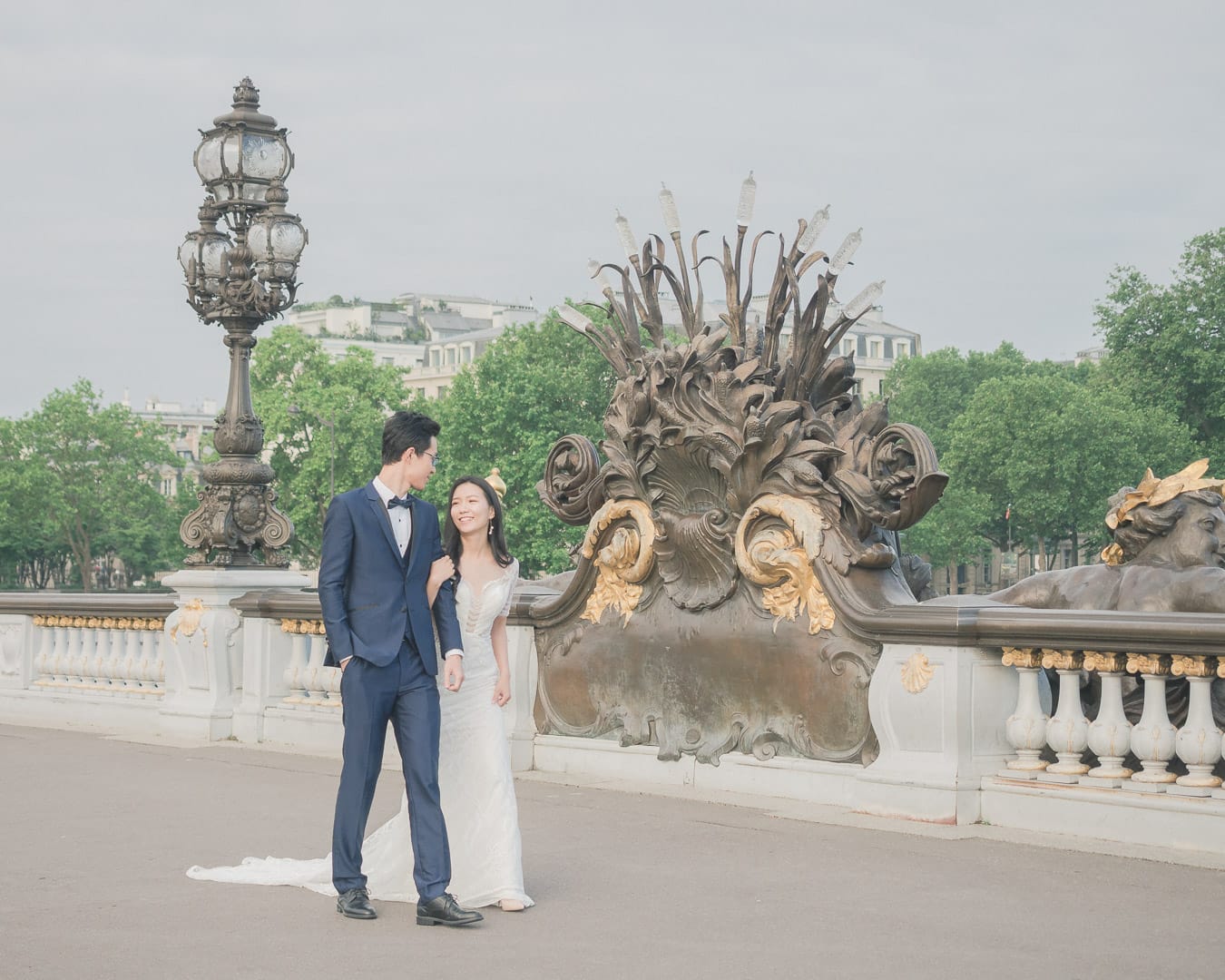 Oriental couple in wedding dress on the Pont Aleandre III