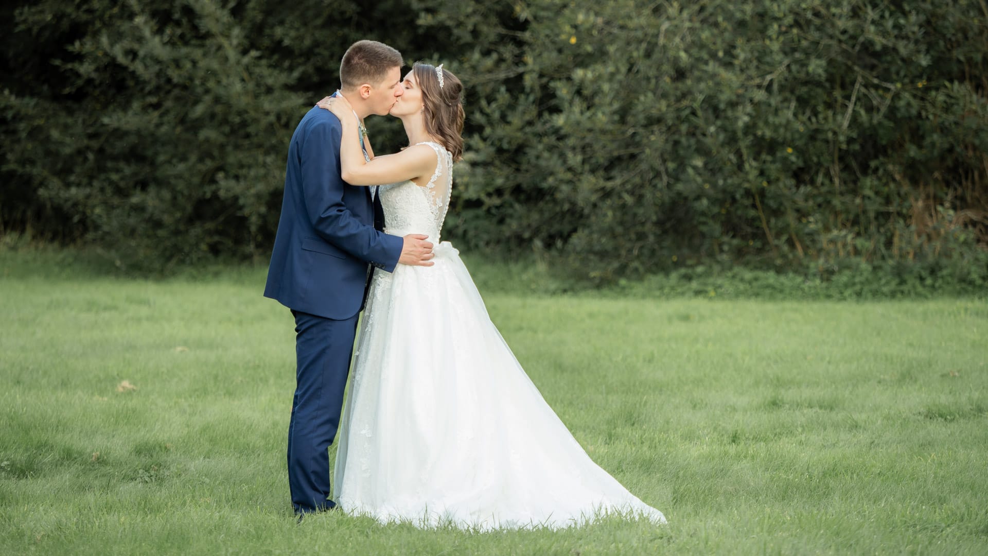 Bride dances with her father while groom dances with his mother on checkerboard floor
