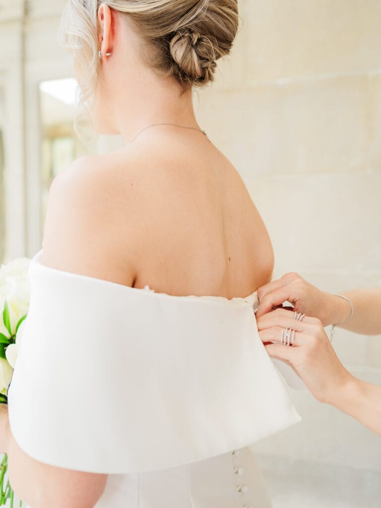 Fastening the back of a bridal gown