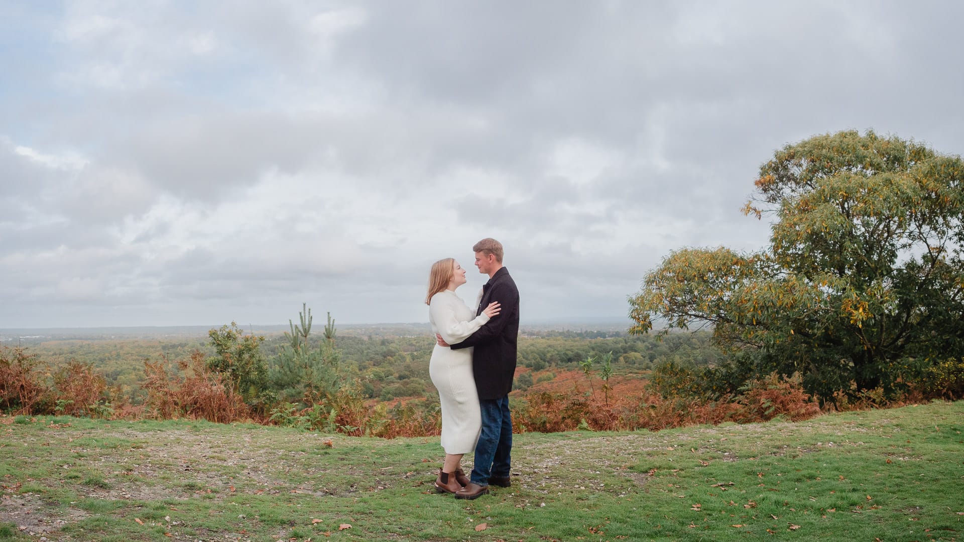 Couple embrace at Caesar's Camp, Hampshire