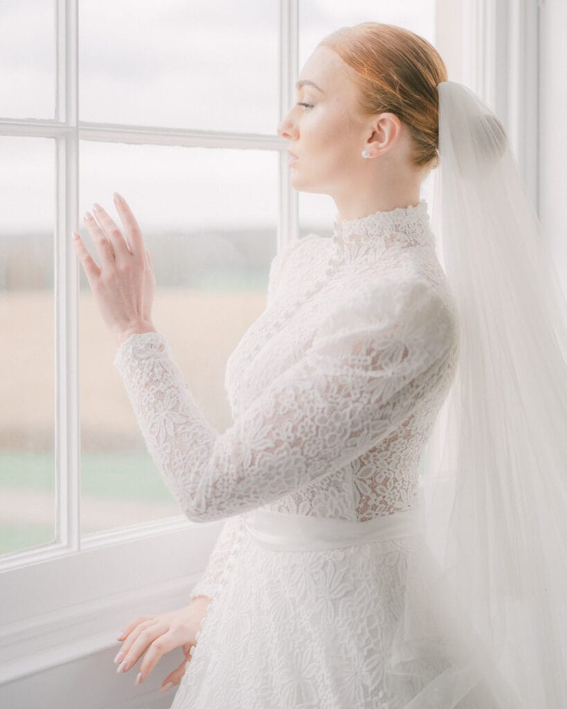 Bride looks out of the window at Rookesbury Park.