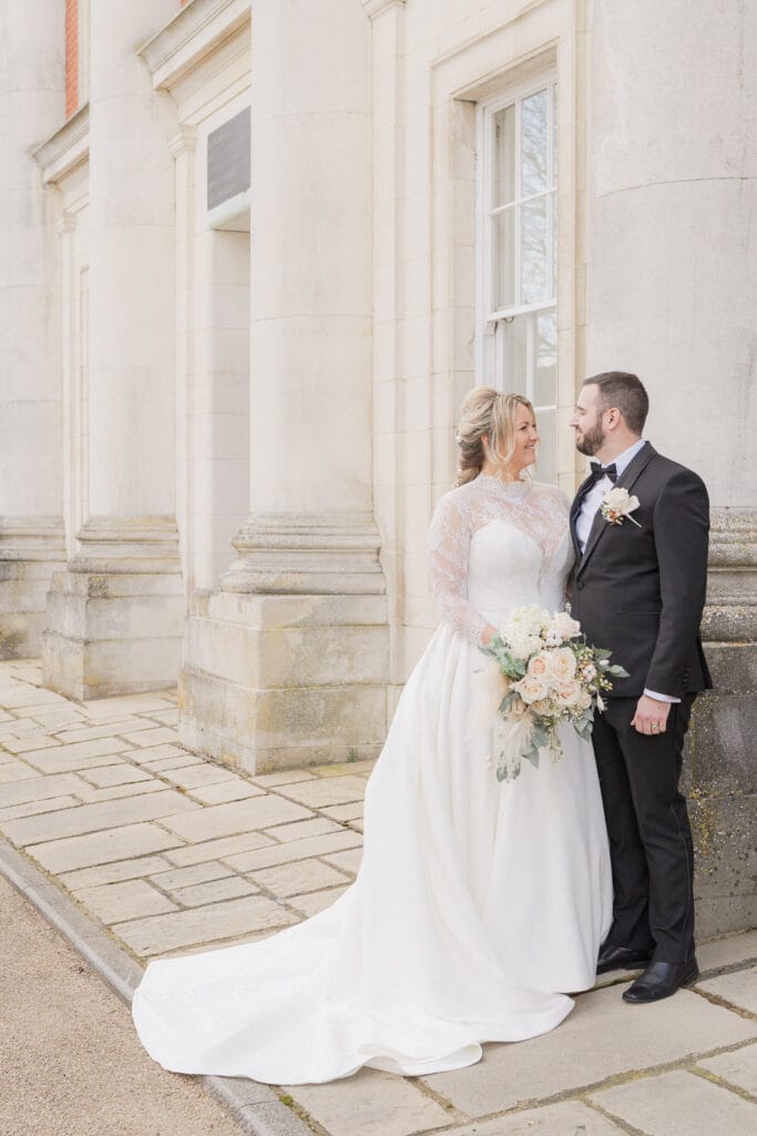 Bride and groom in front of an imposing historical building